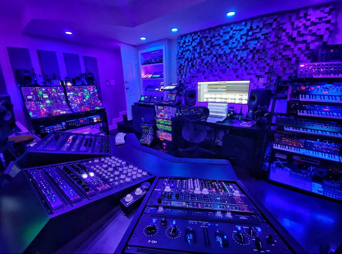 Richard Devine’s music studio equipped with diverse synthesizers and sound equipment.